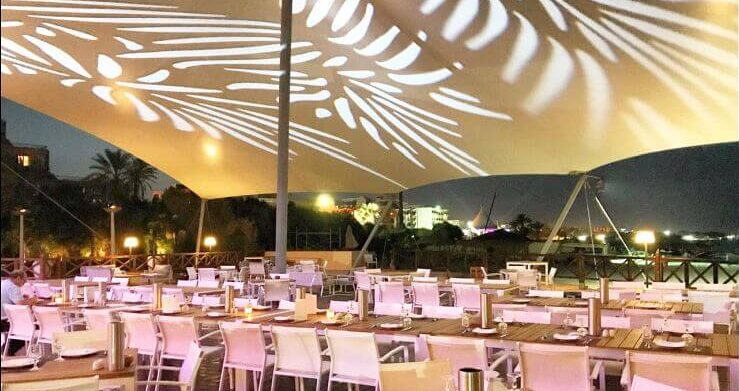 Restaurant élégant sous un auvent lumineux.